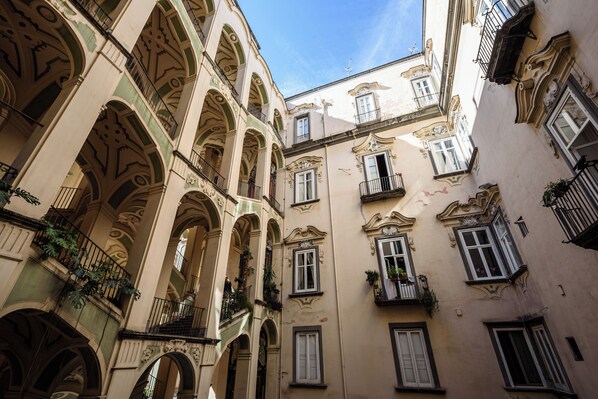 A multi-story building with ornate architectural details, including arches and balconies.