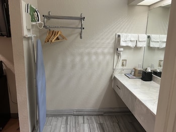 A multi-story hotel with a central courtyard, balconies, and a vending area. at Scott Inn Suites - Downtown Houston