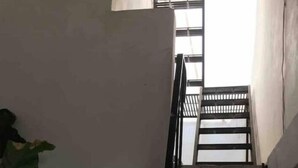 A narrow stairway with a metal handrail leading to a window. - My Depa Vanilla. In the heart of Cd. Valleys. (Ciudad Valles)