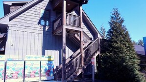 A wooden building with a balcony and stairs. - 4th Street Mkt Apt 302: Convenient Walk to Main Street | 2BR Apt in Highlands (Highlands)
