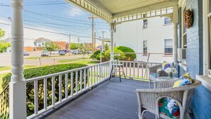 A covered porch with wicker furniture and a view of the street. - One bedroom apartment in downtown Canandaigua (Canandaigua)