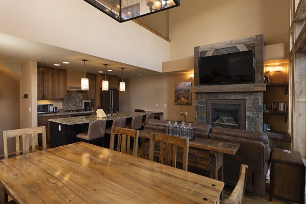 A spacious kitchen with a large island, wooden cabinets, and pendant lighting. - Alpenglow 18 - Managed by Purgatory (Durango)