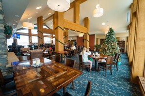 Enjoy group dining in this spacious room with a large wooden table and high ceilings.