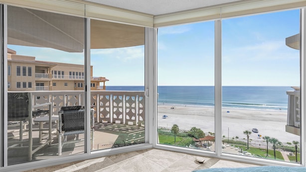 A balcony with a view of the beach and ocean. - Gorgeous Oceanfront View! Walking distance to dining & shopping! (New Smyrna Beach)