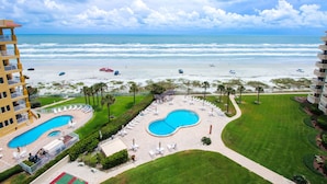 A resort with a pool, beach access, and a view of the ocean. - Gorgeous Oceanfront View! Walking distance to dining & shopping! (New Smyrna Beach)