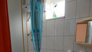 A bathroom with a toilet, sink, and shower curtain. - Apartments Dijana - Studio Apartment with Terrace (Viganj)