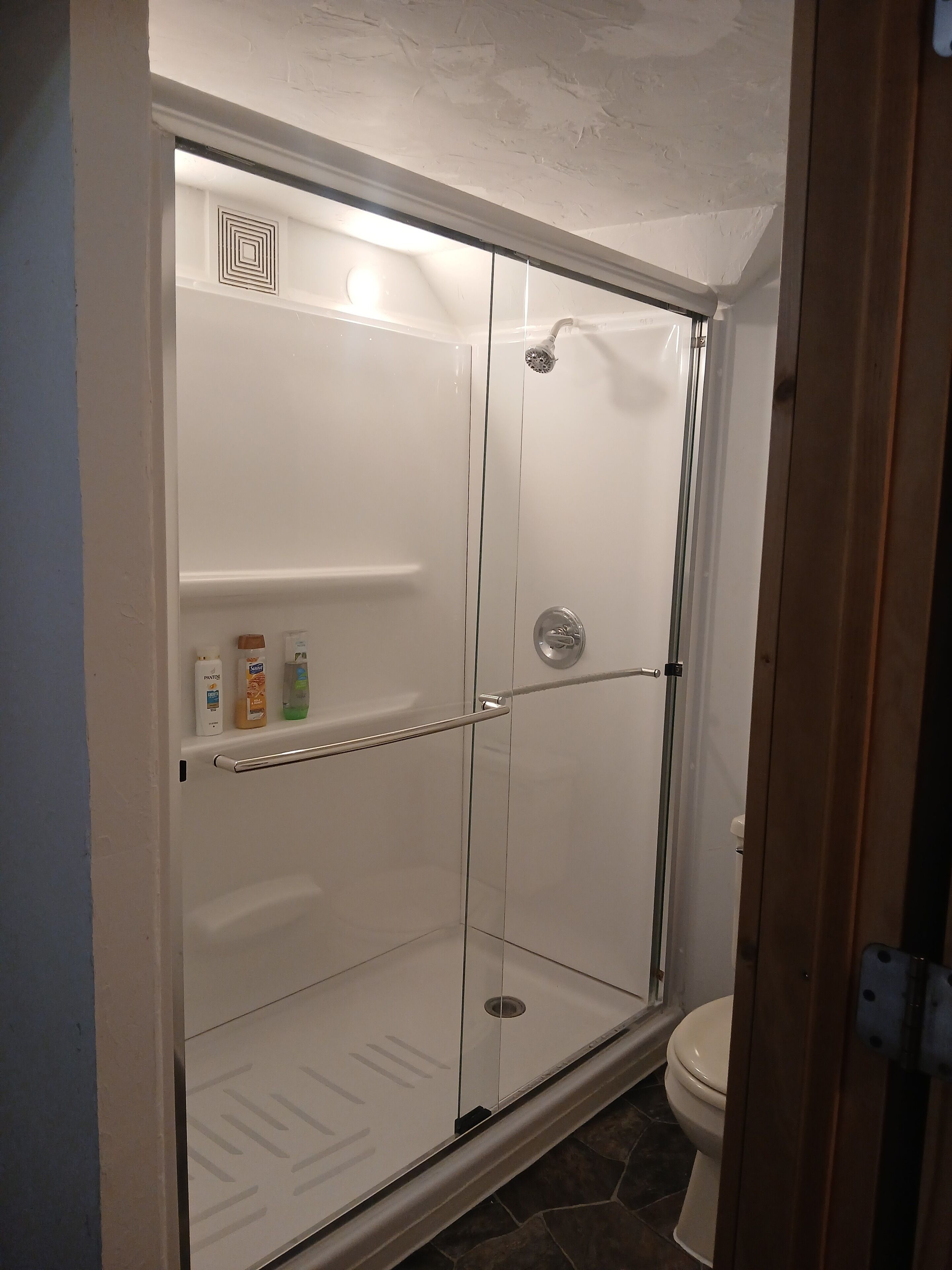 Een douche, handdoeken, zeep, shampoo