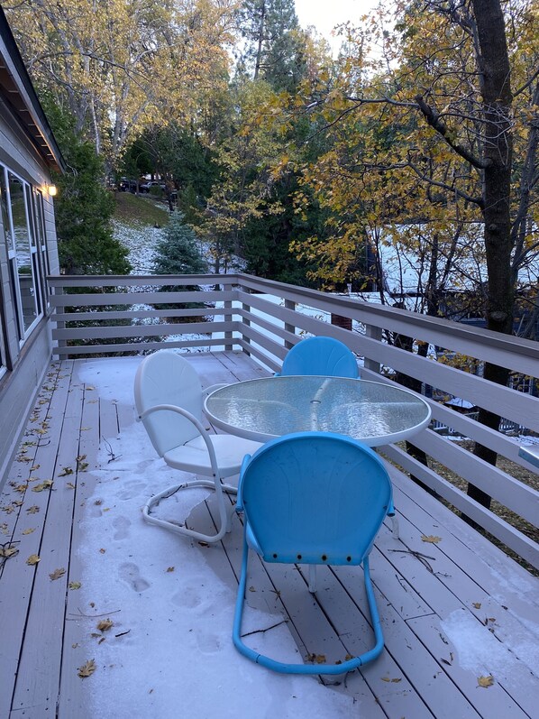 Enjoy a peaceful moment on this outdoor deck surrounded by trees and a serene natural setting.