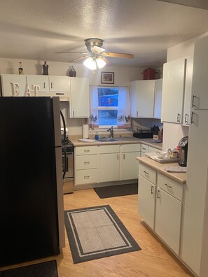 Enjoy cooking in this well-lit kitchen with a central island and ample counter space.