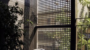 A modern interior with a large window, a round table, and a potted plant. - The Newel Metaxourgeio by Athens Stay (Athens)