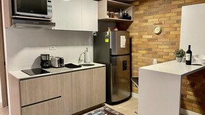 A modern kitchen with a microwave, toaster, and refrigerator.