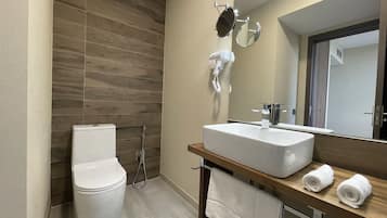 Junior kamer | Badkamer | Een douche, badjassen, pantoffels, een bidet