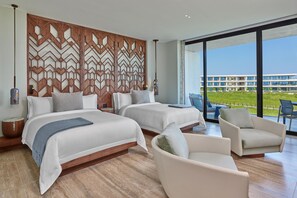 A modern hotel room with two beds, a large window, and a view of a building and greenery outside. - The St. Regis Kanai Resort, Riviera Maya (Playa del Carmen)