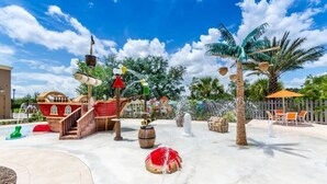 A water play area with a pirate ship, palm trees, and a fountain.