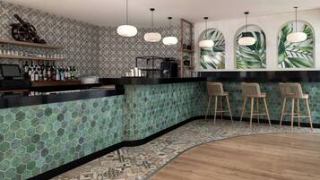 A bar area with a green-tiled backsplash, wooden bar counter, and three bar stools.