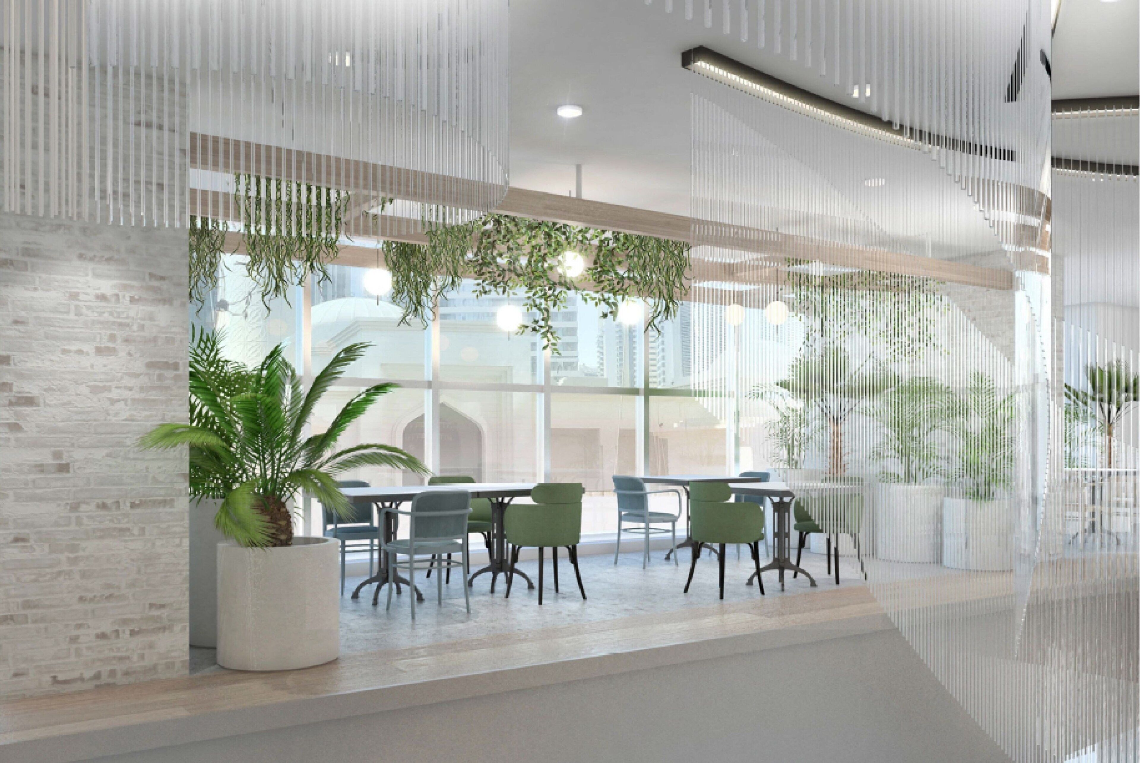 A modern indoor space with a long table and chairs, large windows, and hanging plants.