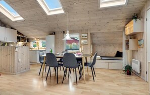 A cozy, well-lit kitchen with a dining area, wooden ceiling, and skylights. - Lovely home in Hadsund with WiFi (Hadsund)