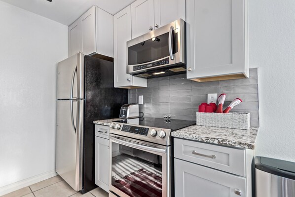 A modern kitchen with stainless steel appliances, a microwave, and a built-in oven.