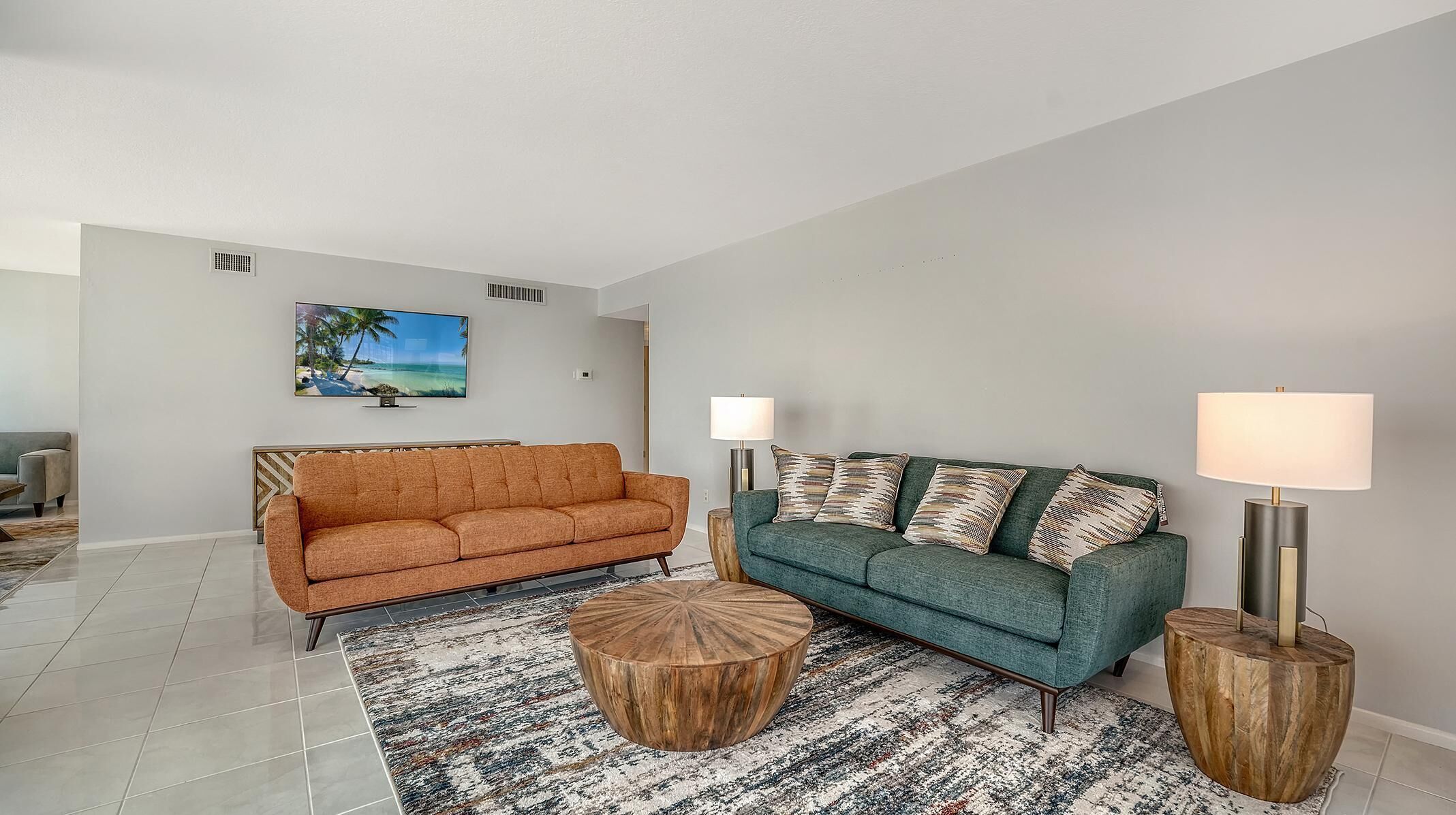 A living room with two sofas, a coffee table, and two floor lamps.
