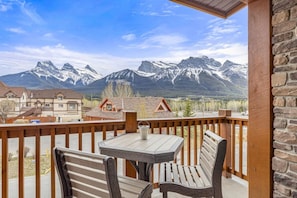 Enjoy a serene view of the snow-capped mountains from the balcony, where you can relax or dine with a table and two chairs.
