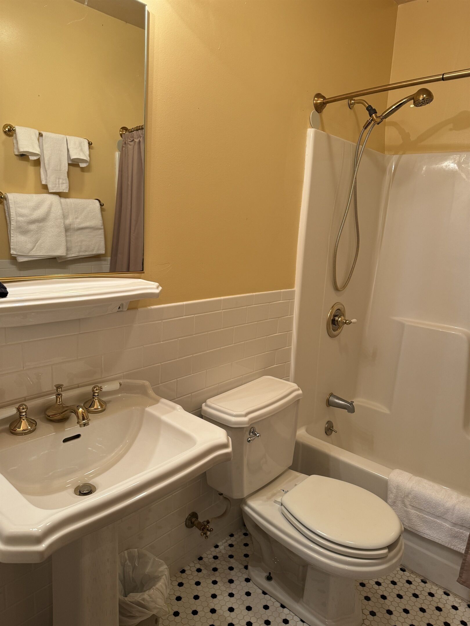 A bathroom with a sink, toilet, and shower.