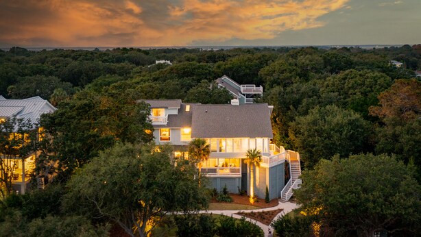 A modern house with a large deck, surrounded by dense trees. - Across street from beach, Renovated, Wild Dunes - 7 Fairway Oaks (Isle Of Palms)