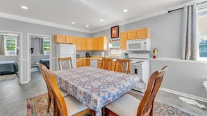 A compact kitchen with wooden cabinets, a microwave, and a stove.