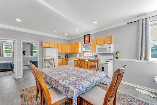 A compact kitchen with wooden cabinets, a microwave, and a stove.