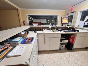 A home office with a desk, computer, telephone, and various office supplies. - Economy Inn Sweetwater I-75 (Sweetwater)