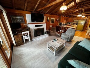 Smart TV, fireplace, books, computer monitors