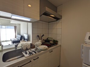 A compact kitchen with a sink, countertop, and a microwave. - ESLEAD HOTEL OSAKA TSURUHASHI (Osaka)