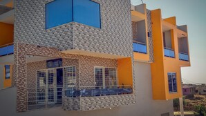 A multi-story building with a modern design, featuring a patterned facade and balconies.