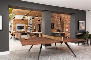Enjoy meals in the dining area with a long table and geometric patterned floor.