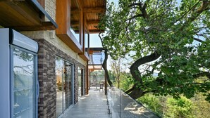 A modern building with large glass windows, a stone facade, and a wooden ceiling. - Stunning Villa with infinity pool, Croatia (Donja Poljana)