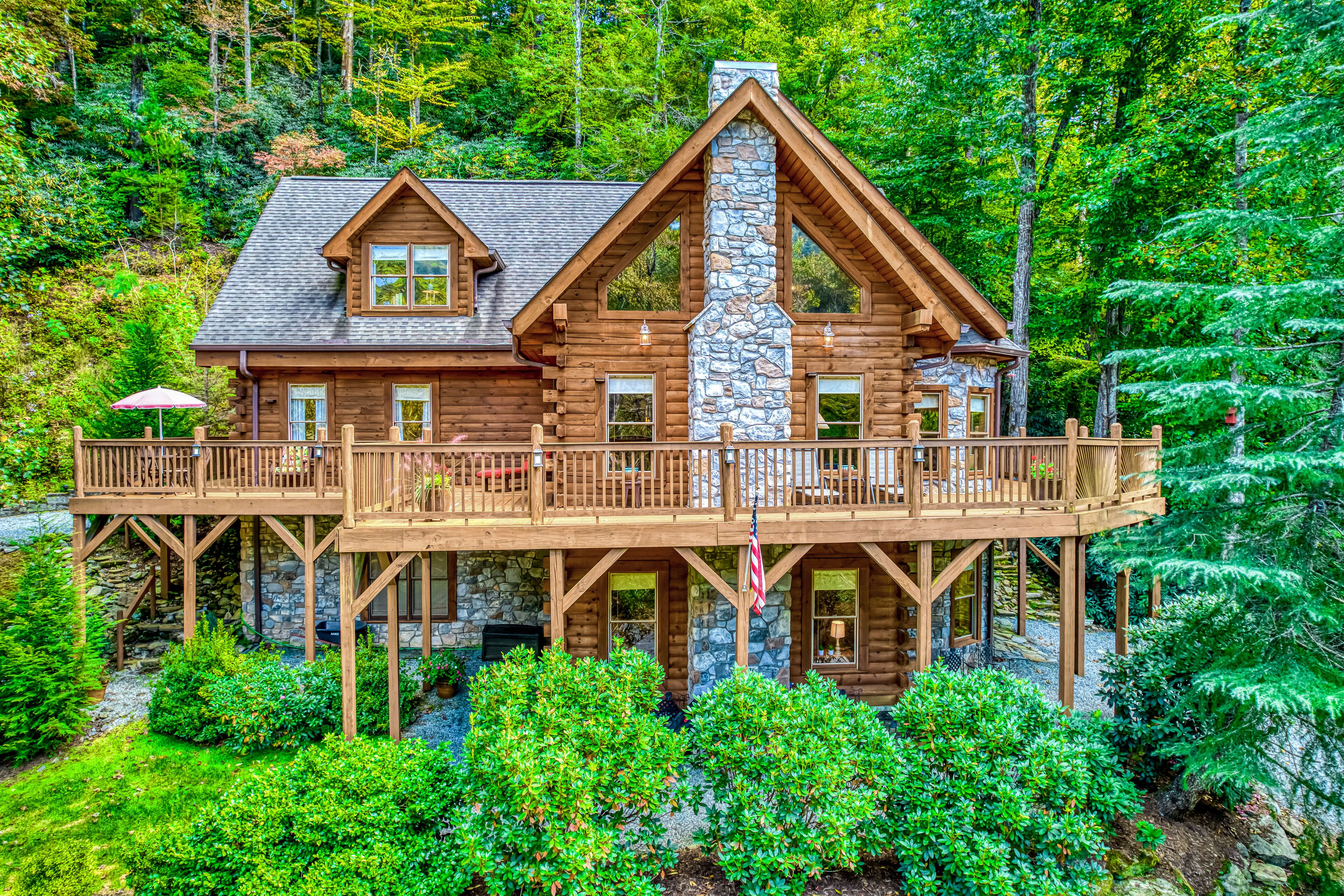 Spacious creekside home with wraparound deck, firepit, fireplaces & bumper pool
