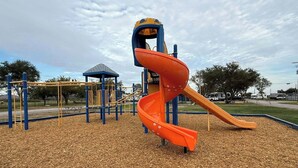 A playground with a spiral slide and climbing structures. - Campsite near Wichita Wildlife Refuge & Mountains (Cache)
