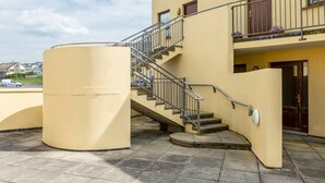 A two-story building with a staircase leading to the upper floor. - Dough Beag 10 (250m to Lahinch Beach), Dough Beag Apartment (Lahinch)