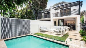 A modern house with a swimming pool, outdoor seating, and a large balcony. - Bondi Coastal Charm ISYD (Bondi Beach)
