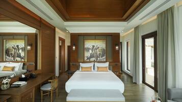 A spacious hotel room with a large bed, wooden paneling, and artwork on the walls.