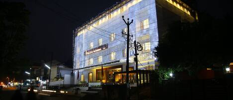 A hotel with a modern facade, multiple floors, and a prominent entrance.