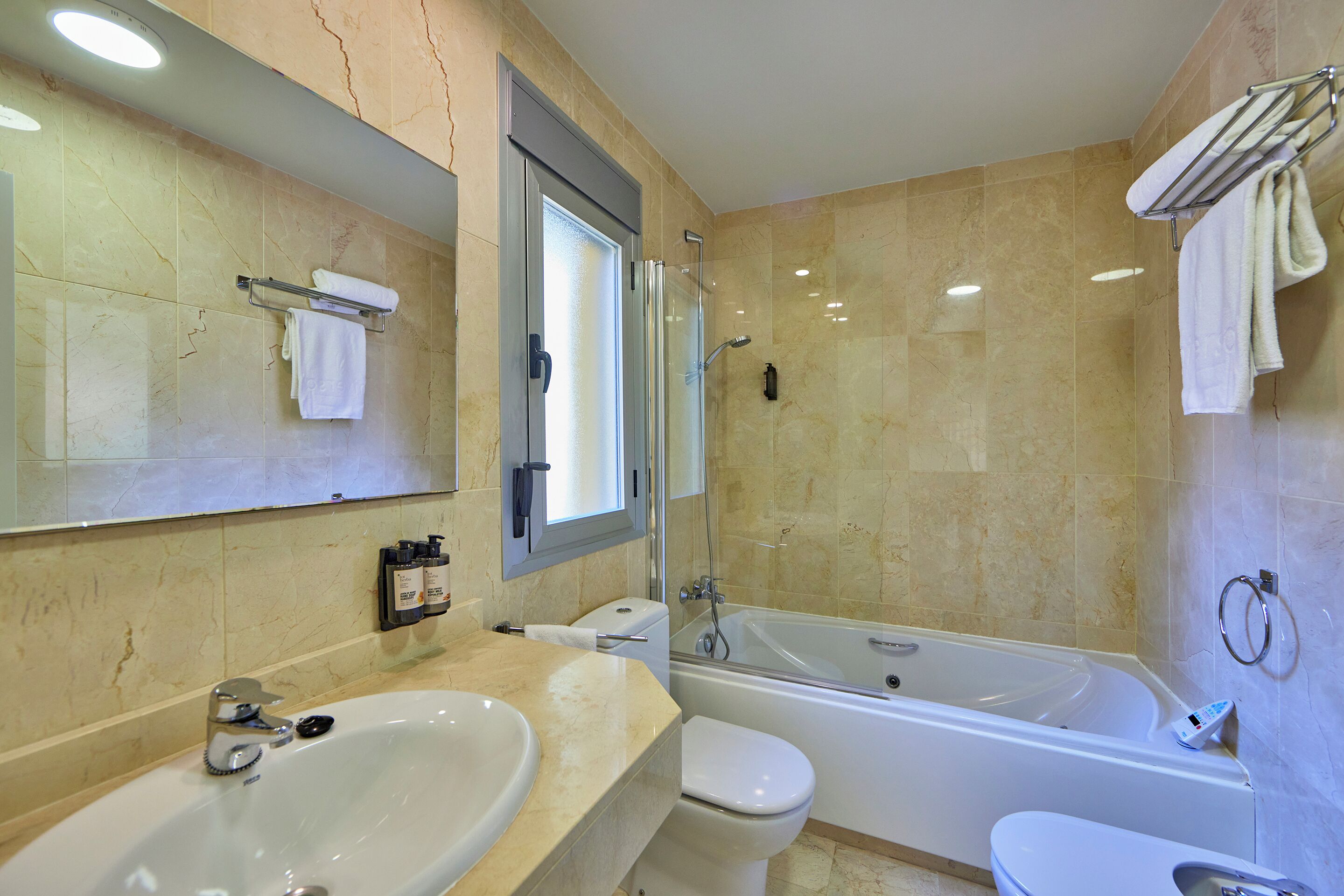 A bathroom with a sink, toilet, and bathtub.