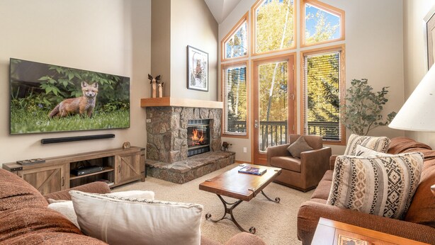 A living room with a fireplace, television, and comfortable seating. - Private Hot Tub. Steps to The Lift. Beautiful Home (Breckenridge)