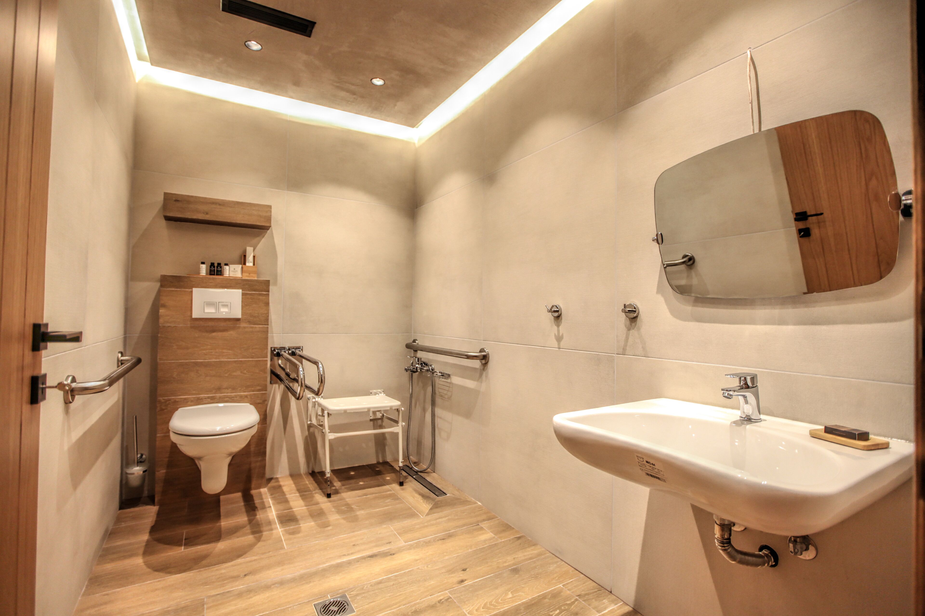 A modern bathroom with a toilet, sink, and shower.