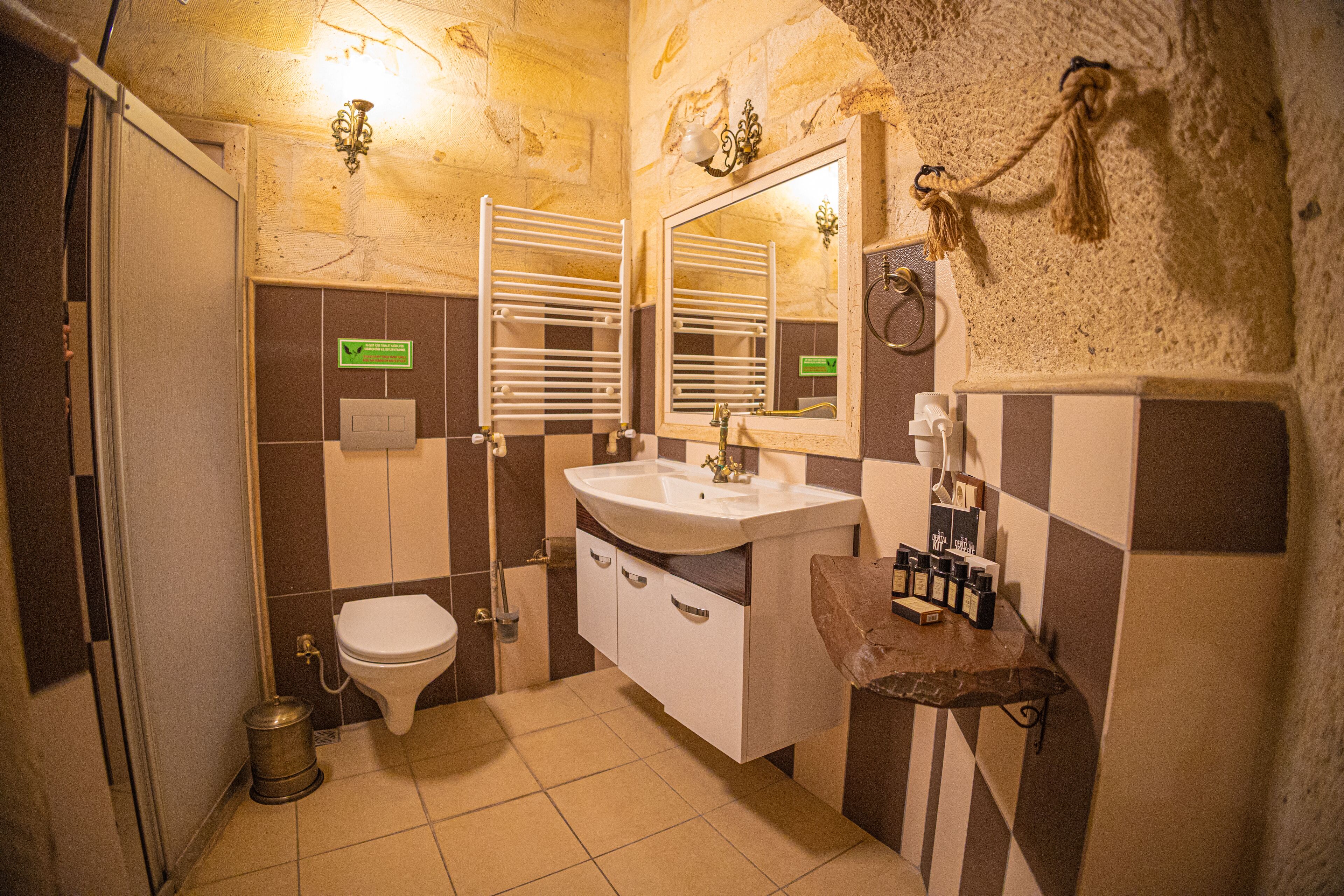 Designer toiletries, hair dryer, slippers, towels