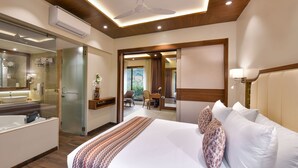 A hotel room with a large bed, a bedside table, a mirror, a ceiling fan, and a view of the outdoors. - Arova Woods Zinc Journey by The Fern (Mawal)