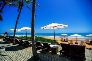 On the beach, white sand, sun loungers, beach umbrellas