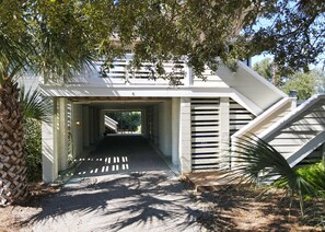 Set amidst lush greenery, this single-story building offers a serene escape with a central entrance and covered area.
