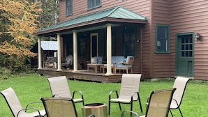 A house with a covered porch, outdoor seating, and a fire pit. - Edgewood, Beautiful custom built 5 bdrm home w/ fire pit, game room, scenic pond (Milford)