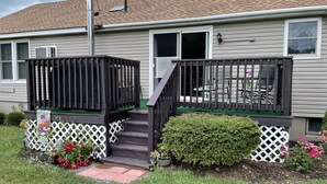 A two-story house with a front porch, a small deck, and a green lawn. - Morgan Farm - Well cared for Ranch house near Canadarago Lake (Richfield Springs)