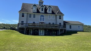 A large, two-story house with a balcony and a small tower-like structure on the roof. - Phoenix Hill - Spacious, 7bdrm home, pool, game room and long distance views (West Oneonta)